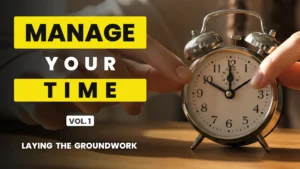 Hand adjusting a vintage alarm clock on a desk beside bold yellow and white text reading “Manage Your Time Vol. 1 Laying the Groundwork” against a soft background
