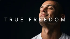 A man with eyes closed in a peaceful expression, overlaid with the text 'TRUE FREEDOM', symbolizing emotional liberation and recovery.